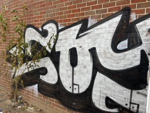 Black and white graffiti on a brick wall in Columbia Heights